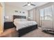 Primary bedroom showcasing a large bed, ceiling fan, and natural light from windows at 6834 Clay N St, Denver, CO 80221