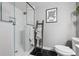 Modern shower with sleek tiles, a glass enclosure, and rainfall shower head at 6834 Clay N St, Denver, CO 80221