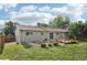 A view of the home's backyard, complete with garden beds and a wooden deck, perfect for outdoor enjoyment at 4759 S Xenophon St, Morrison, CO 80465