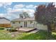 The home's backyard features a cozy deck and garden beds, offering a peaceful outdoor space for relaxation and gardening at 4759 S Xenophon St, Morrison, CO 80465