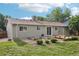 Backyard view highlighting garden beds and wooden deck, ideal for outdoor entertaining and relaxation at 4759 S Xenophon St, Morrison, CO 80465
