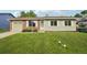 Charming single-story home featuring a well-manicured lawn, brick accents, and a convenient attached garage at 4759 S Xenophon St, Morrison, CO 80465