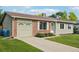 Charming single-story home featuring a well-manicured lawn, brick accents, and a convenient attached garage at 4759 S Xenophon St, Morrison, CO 80465