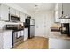 Kitchen features stainless steel appliances, granite countertops, and ample cabinet space at 4759 S Xenophon St, Morrison, CO 80465