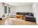 Bright living room with hardwood floors, large windows, and a comfortable gray sectional sofa at 4759 S Xenophon St, Morrison, CO 80465