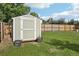 Backyard storage shed surrounded by a well-maintained lawn, ideal for storing gardening tools and outdoor equipment at 4759 S Xenophon St, Morrison, CO 80465