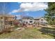A sprawling backyard with a stone patio, outdoor seating, a fire pit, and an installed water feature at 2208 Bellavista St, Castle Rock, CO 80109