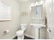 Charming half bathroom featuring modern sink, toilet, and rustic decorations at 2208 Bellavista St, Castle Rock, CO 80109