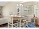 Bright dining area showcasing a wooden table with seating for six, a modern chandelier, and abundant natural light at 2208 Bellavista St, Castle Rock, CO 80109