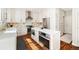 Well-equipped kitchen with white cabinets, stainless steel appliances, and quartz countertops at 2208 Bellavista St, Castle Rock, CO 80109