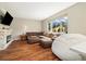 Cozy living room featuring a stone fireplace, comfortable sectional seating, and a scenic outdoor view at 2208 Bellavista St, Castle Rock, CO 80109