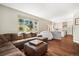 Spacious living room with hardwood floors, comfortable sectional sofa, and view of the backyard at 2208 Bellavista St, Castle Rock, CO 80109
