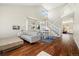 Bright living room featuring soaring ceilings, hardwood floors, a modern staircase, and a dining area at 2208 Bellavista St, Castle Rock, CO 80109