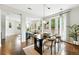 Elegant dining area featuring modern table, stylish chairs, and natural light, open to living space at 2648 Florence St, Denver, CO 80238