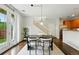 Bright dining area featuring stylish furniture with seamless access to the staircase, kitchen and backyard at 2648 Florence St, Denver, CO 80238