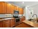 Updated kitchen with stainless steel oven, microwave, light wood cabinets and sink at 2648 Florence St, Denver, CO 80238