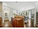 Modern kitchen featuring stainless steel appliances, hardwood floors, and an island overlooking the dining area at 2648 Florence St, Denver, CO 80238
