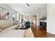 Spacious living room with hardwood floors, contemporary furniture, and seamless flow into dining and kitchen at 2648 Florence St, Denver, CO 80238