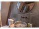 Stylish bathroom features a round sink, a skylight, and a gray tiled wall design at 563 Cr 672, Breckenridge, CO 80424