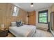 Bright bedroom with a window view and wood-paneled walls, creating a cozy and inviting space at 563 Cr 672, Breckenridge, CO 80424