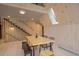 A dining area featuring a light wood table, modern chairs and bench seating plus staircase with wood slat wall at 563 Cr 672, Breckenridge, CO 80424