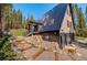 Exterior side view of A-frame home showcasing unique architectural design and details at 563 Cr 672, Breckenridge, CO 80424