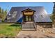Modern A-frame home exterior showcasing unique architectural details and landscaping at 563 Cr 672, Breckenridge, CO 80424