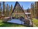 A-frame house exterior view from deck, showcasing the surrounding wooded area at 563 Cr 672, Breckenridge, CO 80424