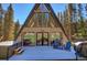 Exterior of modern A-frame home with deck, hot tub, and outdoor seating at 563 Cr 672, Breckenridge, CO 80424