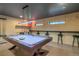 Basement game room features a pool table, high-top seating, and small windows for natural light at 563 Cr 672, Breckenridge, CO 80424