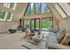 Bright and airy living room with vaulted wood ceilings, modern furniture, and views of the landscaped backyard at 563 Cr 672, Breckenridge, CO 80424