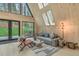 Cozy living room featuring a comfortable couch, stylish decor, large windows with view of outdoor hot tub and greenery at 563 Cr 672, Breckenridge, CO 80424