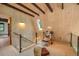 Comfortable loft area with glass railings and natural wood finishes, and light filled stairwell at 563 Cr 672, Breckenridge, CO 80424
