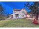 Charming home with a well-manicured lawn, bay window, and inviting front porch at 9310 S Watson Gulch Rd, Littleton, CO 80127