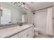 Bathroom featuring decorative lighting, sink and shower with white tile at 11715 Crow Hill Dr, Parker, CO 80134