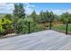 A spacious deck with dark metal railings offers a relaxing outdoor space and serene backyard views at 11715 Crow Hill Dr, Parker, CO 80134
