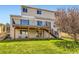 Exterior view of a two-story home featuring a deck, well-manicured lawn and a stairway to the yard at 11715 Crow Hill Dr, Parker, CO 80134