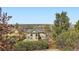Exterior of home showcasing neighborhood views, mature trees, and landscaped surroundings for privacy and beauty at 11715 Crow Hill Dr, Parker, CO 80134