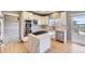 Modern kitchen featuring white cabinets, stainless steel appliances, hardwood floors, and island at 11715 Crow Hill Dr, Parker, CO 80134