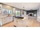 Updated kitchen with white cabinets and stainless appliances that opens to the living room at 11715 Crow Hill Dr, Parker, CO 80134