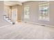 Bright living room with neutral carpet, fresh paint, and staircase at 11715 Crow Hill Dr, Parker, CO 80134