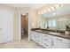 Bathroom featuring double sinks, granite countertop, and a separate toilet room at 9912 Silver Maple Rd, Highlands Ranch, CO 80129