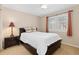 Bedroom with white bedding, dark furniture and shutters on the window at 9912 Silver Maple Rd, Highlands Ranch, CO 80129