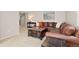 Cozy living room with brown leather couch and dark wood coffee table at 9912 Silver Maple Rd, Highlands Ranch, CO 80129