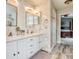 Bright bathroom featuring double sinks, marble countertops, and elegant fixtures at 22160 Wintergreen Way, Parker, CO 80138