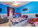 Spiderman themed bedroom with twin bed, blue walls and a grey chair at 22160 Wintergreen Way, Parker, CO 80138