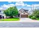 Inviting two-story home with a cozy front porch and a well-manicured lawn at 22160 Wintergreen Way, Parker, CO 80138