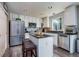 Bright kitchen featuring stainless steel appliances, island seating, and modern finishes at 22160 Wintergreen Way, Parker, CO 80138