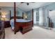 Serene bedroom with a four-poster bed, soft lighting, and elegant window treatments at 22160 Wintergreen Way, Parker, CO 80138