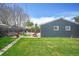 Exterior of home features a lush backyard, a quaint patio, and privacy fence at 833 Osceola St, Denver, CO 80204